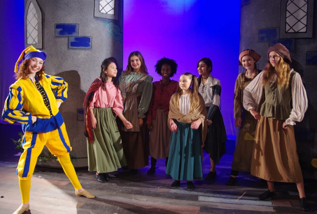 Mopsy and the kids ensemble having a good time on the set of King Arthur's Court.
